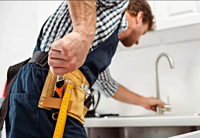Expert plumber demonstrating precision in new faucet installation.