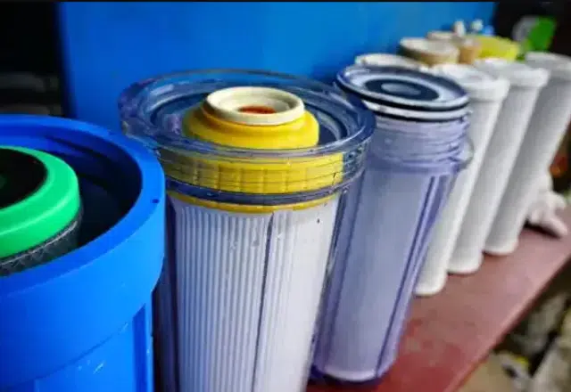Skilled plumbing service installing reverse osmosis filter for household use.