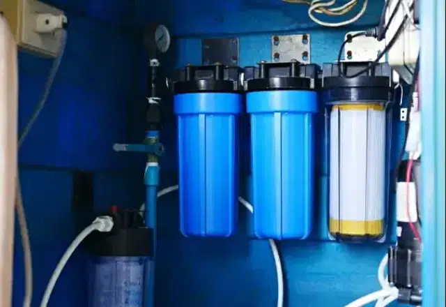 Expert technician installing reverse osmosis filter for clean water.