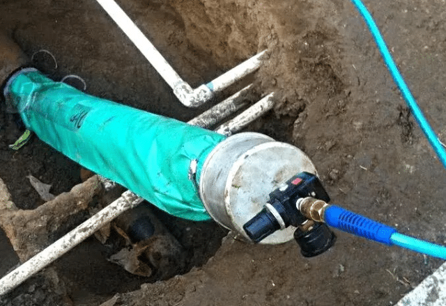 Professional utilizing trenchless techniques for seamless underground pipe rehabilitation