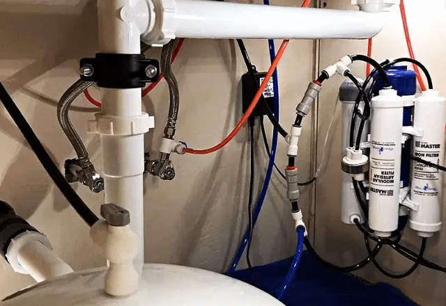 Detailed setup of reverse osmosis filtration system for home use.