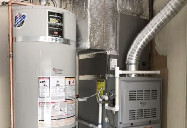 A single water heater connected to a HVAC system, showcasing a setup that may need emergency water heater repair.