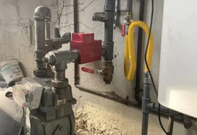 Complex gas line configuration with multiple valves and a yellow flex pipe, often checked for gas line leak repairs.
