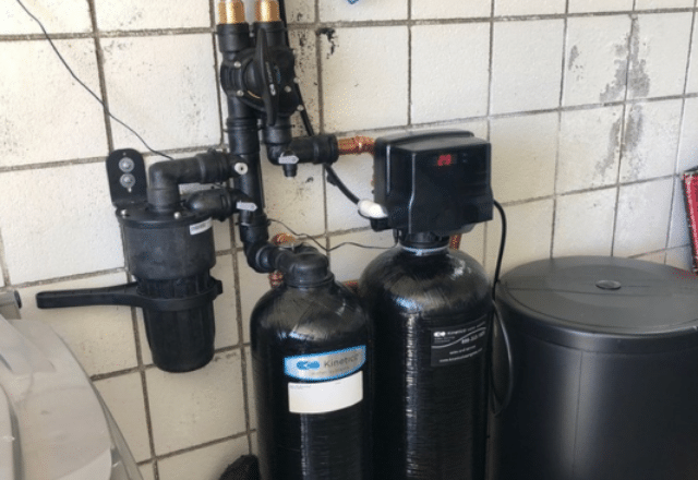 Water softener setup, black tanks, and filtration unit, highlighting components often inspected during water softener repair.