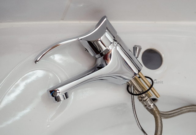 Close-up of a shiny new faucet installation with flexible connectors, a common task for a plumber in San Jose