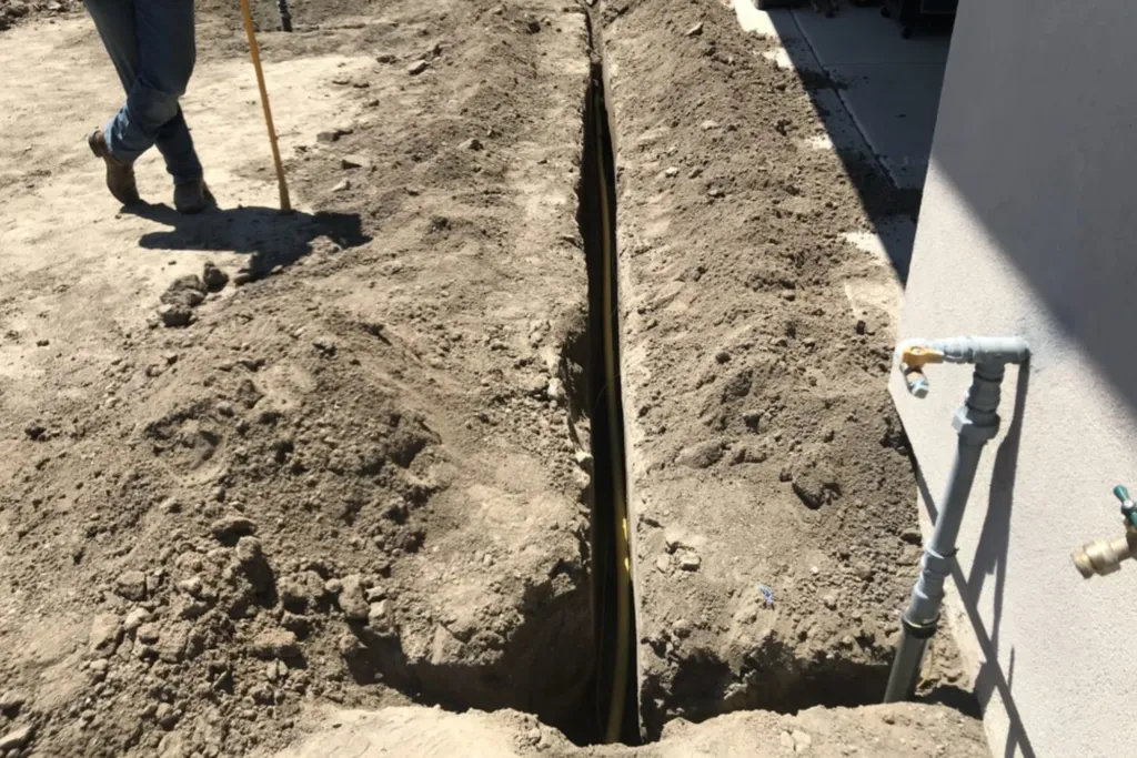 Outdoor trench excavated for installing and repairing a residential gas line.
