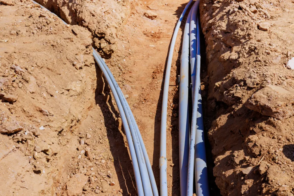 Blue polyethylene main water supply lines laid in an underground trench