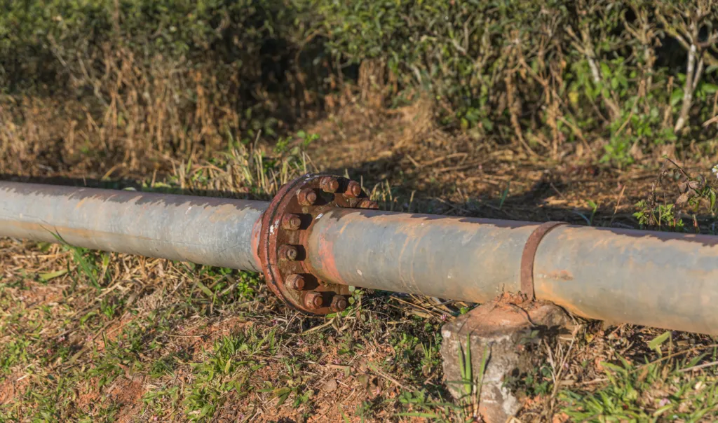Blue polyethylene main water supply lines laid in an underground trench