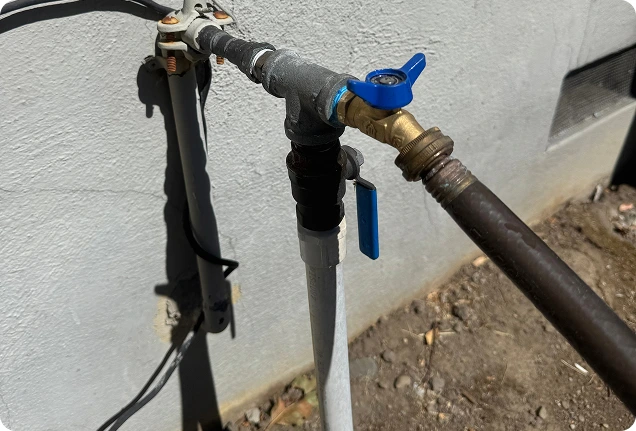 Outdoor main water shutoff valve and copper piping installed on a home exterior in Citrus Heights.