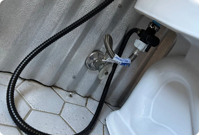 Close up of a new toilet water supply line and angle stop valve installed in Elk Grove.