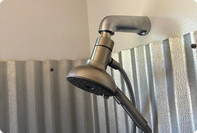 Close up of a newly installed metal shower head in an Elk Grove home bathroom.