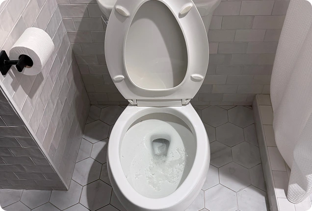 Top-down view of a newly installed white ceramic toilet bowl in a Folsom bathroom.