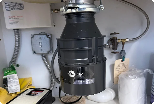 New InSinkErator garbage disposal unit installed under a kitchen sink in Roseville.