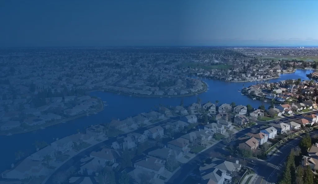 Aerial twilight view of houses and water features in Elk Grove, California.