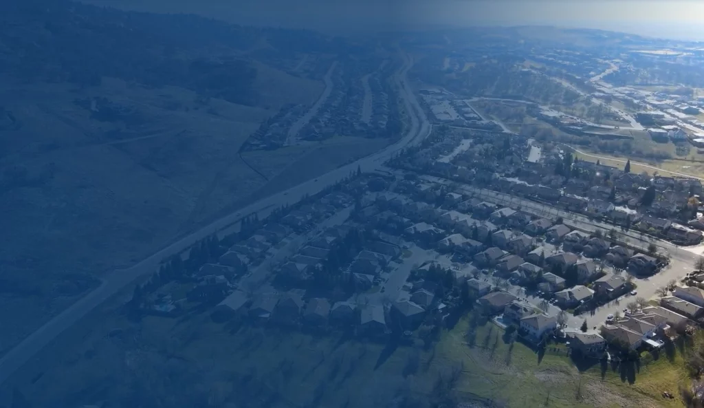 Aerial view of suburban housing developments and landscapes in Folsom, California.